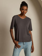 Woman wearing dark gray pure silk V-neck T-shirt with short sleeves