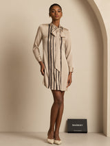 Beige silk tie-neck shirt dress with vertical pleats and long sleeves