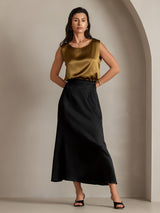 Gold silk sleeveless round neck tank top with black midi skirt