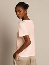 Model wearing blush pink silk jersey short sleeve round neck T-shirt