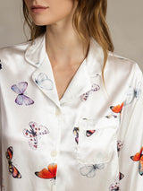 Women's white mulberry silk pajama top with butterfly print, notch collar, and front pocket