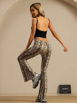 Model wearing high-waisted snake print silk flare pants with slim fit and bell bottoms
