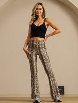 Women’s high-waisted snake print silk flare pants on model