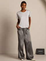 Women’s silk jersey short sleeve round neck T-shirt in white, styled with gray satin pants