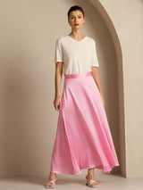 Model wearing a pink silk A-line maxi skirt with lining and a white top