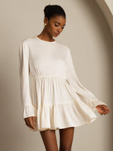 Model wearing ivory silk ruffle sleeve short A-line dress with tiered flowy skirt