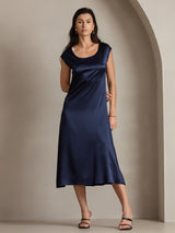 Navy silk midi dress with round neck and cap sleeves on model