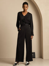 Black silk blend wide-leg high-waist pants styled with a matching V-neck blouse