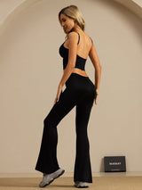 Black high-waisted silk flare pants on model, slim fit bell-bottom style