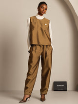 Brown silk-wool blend women’s vest with button pockets over white turtleneck