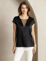 Black silk round neck cap sleeve top with sheer V insert, paired with white pants