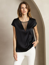 Black silk round neck cap sleeve top with sheer V insert, styled with white pants