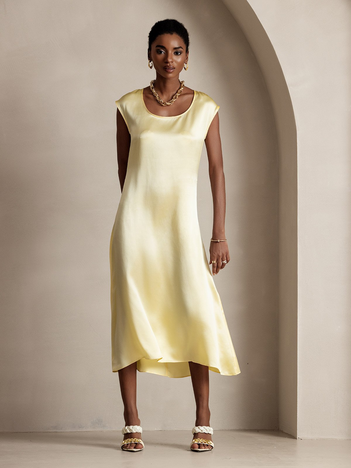 Pale yellow silk midi dress with round neck and cap sleeves