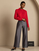 Model wearing red silk stand collar blouse with bow and gray wide-leg pants