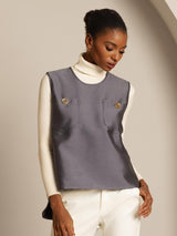 Gray silk-wool blend women's vest with button pockets over a white turtleneck