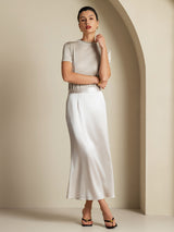 Model wearing a 19 momme silk A-line maxi skirt with side zipper in ivory
