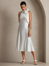 Model wearing a white silk sleeveless tie-neck midi dress