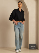 Black silk cropped blouse with half sleeves and drawstring hem styled with light blue jeans