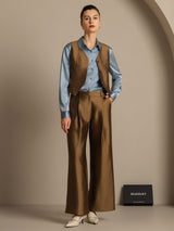 Model wearing silk-wool blend wide-leg pants with matching vest and blue shirt