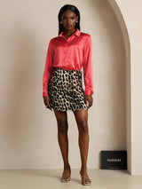 Model wearing pink silk long sleeve lapel shirt with leopard print mini skirt