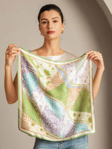 Woman holding a 100% mulberry silk patchwork square scarf with green trim