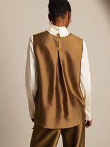 Back view of brown silk-wool women’s vest with button closure, layered over a white blouse