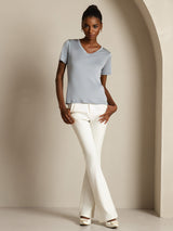Model wearing light blue pure silk V-neck short-sleeve T-shirt with white pants