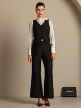 Black silk-wool blend women's vest with button front worn over white blouse and wide-leg pants