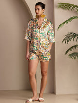 Woman wearing a multicolor crocodile print silk pajama set with short sleeves and shorts