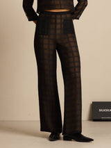 Black silk high-waist wide-leg pants with textured grid pattern and pockets
