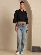 Black silk cropped blouse with half sleeves and drawstring hem, styled with jeans