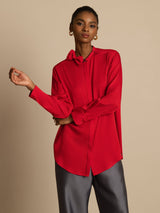 Woman wearing red silk long sleeve stand collar blouse with bow detail
