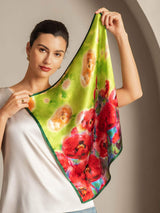 Woman holding green floral 100% mulberry silk square scarf with red and pink flowers