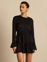 Black silk A-line dress with long sleeves, ruffle cuffs and tiered hem