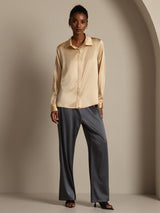 Model wearing champagne silk long sleeve lapel shirt with concealed button front