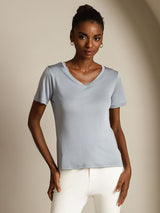 Model wearing light blue pure silk V-neck short sleeve T-shirt with slim fit