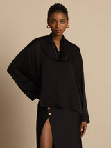 Black silk asymmetrical V-neck blouse with long sleeves and draped tie neckline