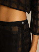 Black high-waist textured grid silk pants with side zipper and crystal button