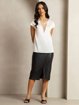 White silk round neck cap sleeve top with sheer V insert, styled with black skirt