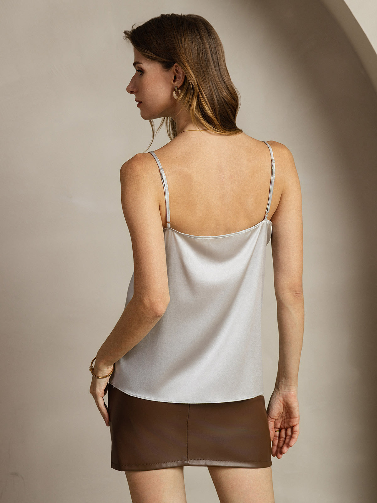 Back view of woman wearing a silver 19 momme silk spaghetti strap camisole