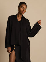 Black silk asymmetrical tie V-neck blouse with long sleeves and relaxed fit
