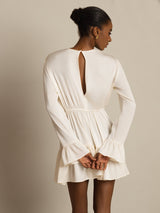 Back view of a white silk A-line dress with ruffle sleeves and keyhole back