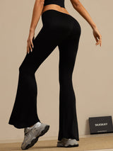 Black high-waisted silk jersey flare pants on model