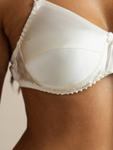White silk bra with smooth cups and adjustable straps on model