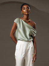 Light green silk one-shoulder top with draped neckline and short sleeve