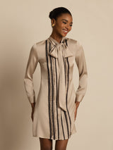 Beige silk tie-neck short shirt dress with vertical pleats and lace stripes