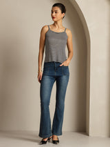 Black and white striped silk camisole top with spaghetti straps, modeled with jeans