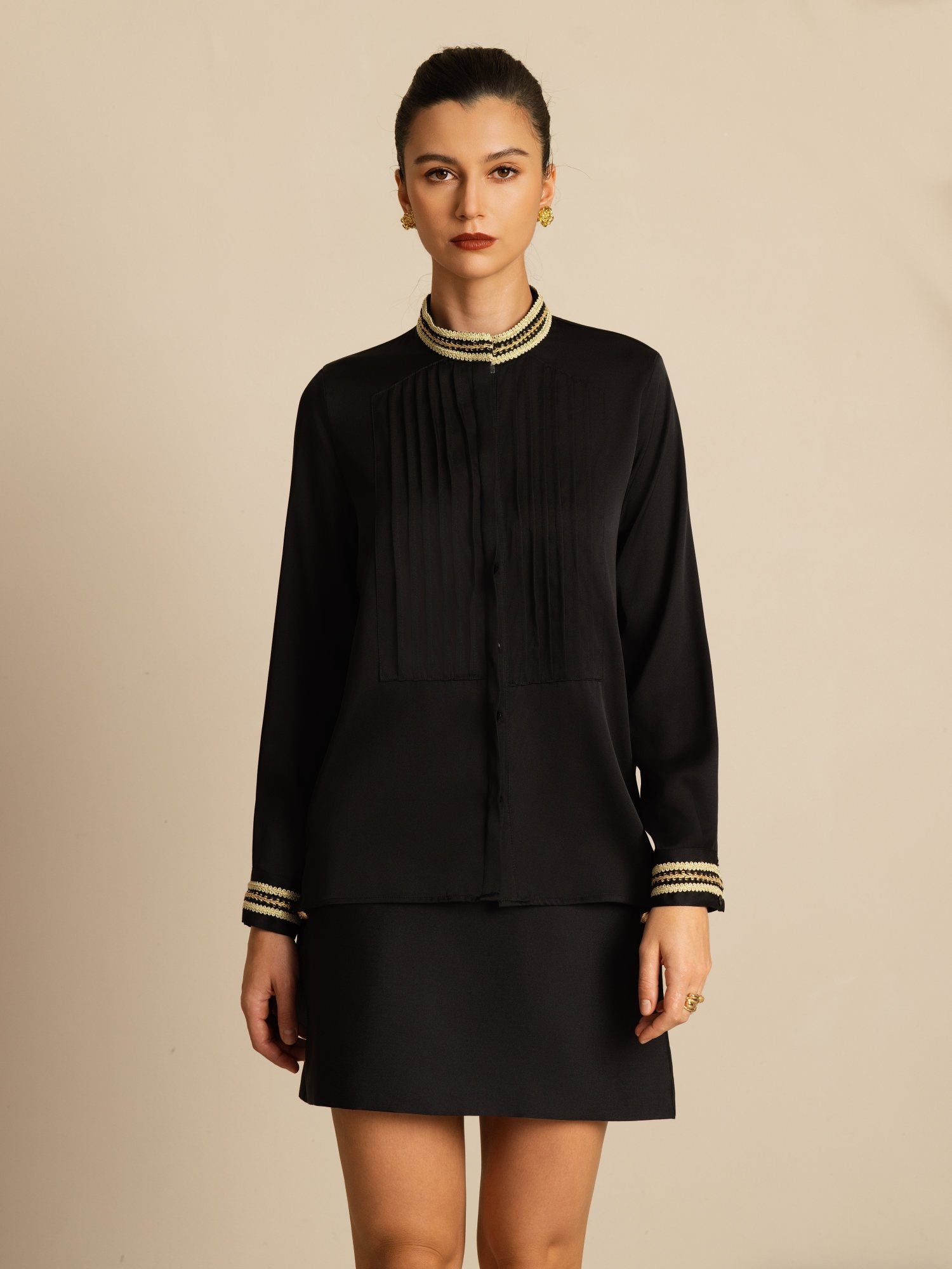 Black silk pleated stand collar blouse with gold trim and long sleeves