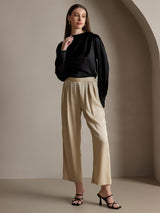 Black silk long sleeve boat neck blouse with beige wide-leg pants