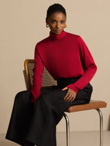 Model wearing red silk turtle neck long sleeve top with black wide-leg pants
